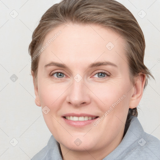 Joyful white young-adult female with medium  brown hair and blue eyes