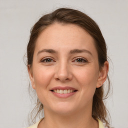 Joyful white young-adult female with medium  brown hair and brown eyes