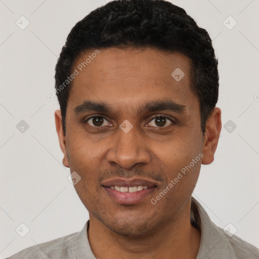 Joyful black young-adult male with short  black hair and brown eyes