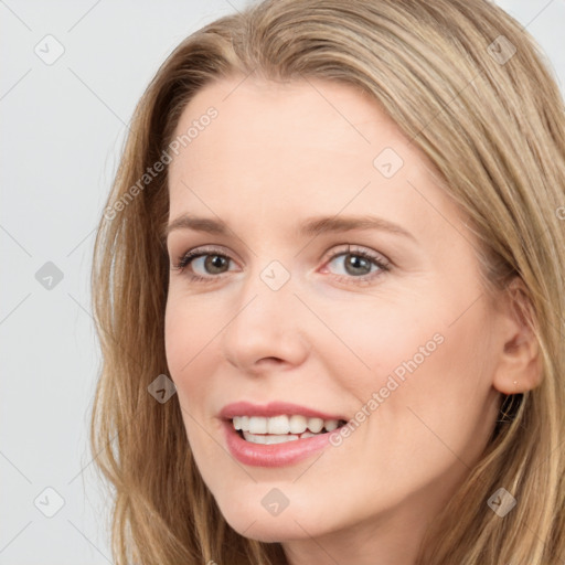 Joyful white young-adult female with long  brown hair and blue eyes