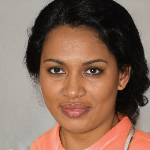 Joyful black adult female with medium  black hair and brown eyes