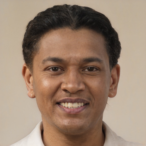Joyful latino adult male with short  brown hair and brown eyes