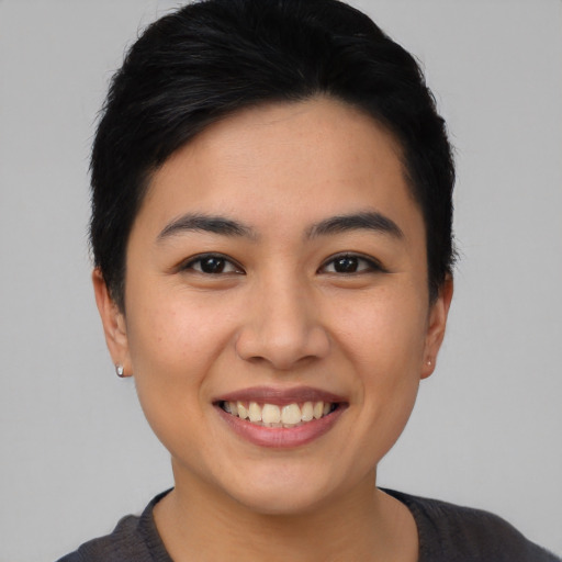 Joyful asian young-adult female with short  black hair and brown eyes