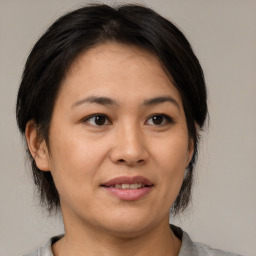 Joyful white adult female with medium  brown hair and brown eyes