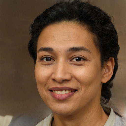 Joyful latino adult female with short  brown hair and brown eyes