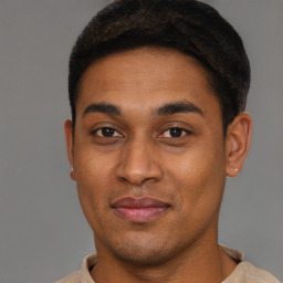 Joyful black young-adult male with short  brown hair and brown eyes