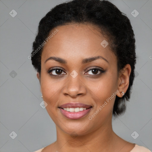 Joyful black young-adult female with short  black hair and brown eyes