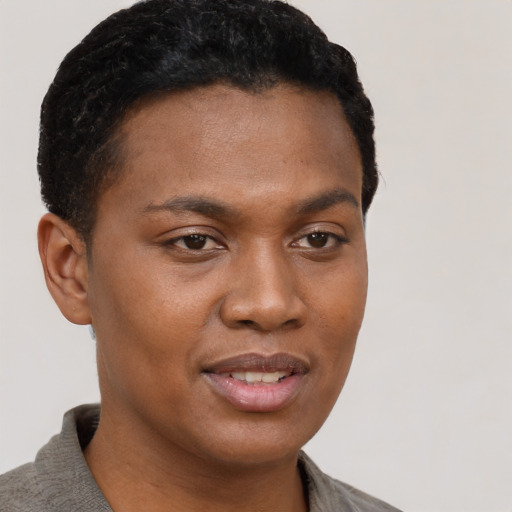 Joyful black young-adult female with short  brown hair and brown eyes