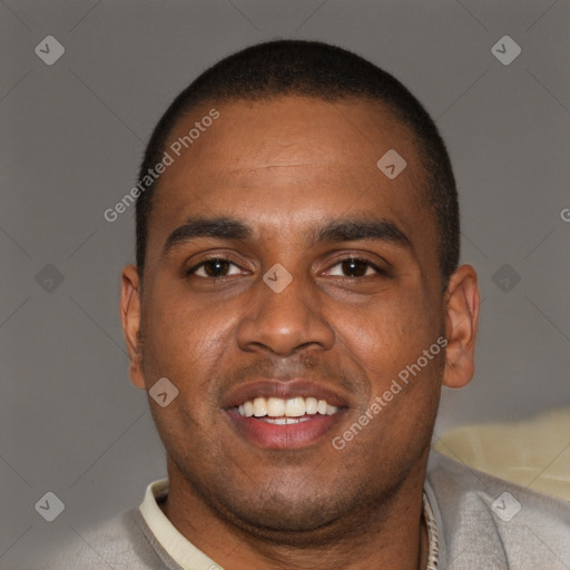 Joyful black young-adult male with short  brown hair and brown eyes