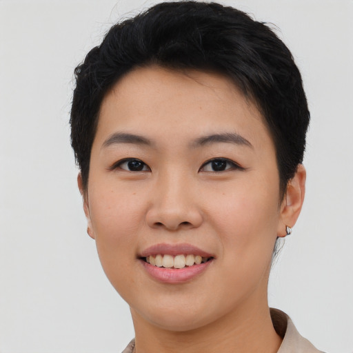 Joyful asian young-adult female with short  black hair and brown eyes