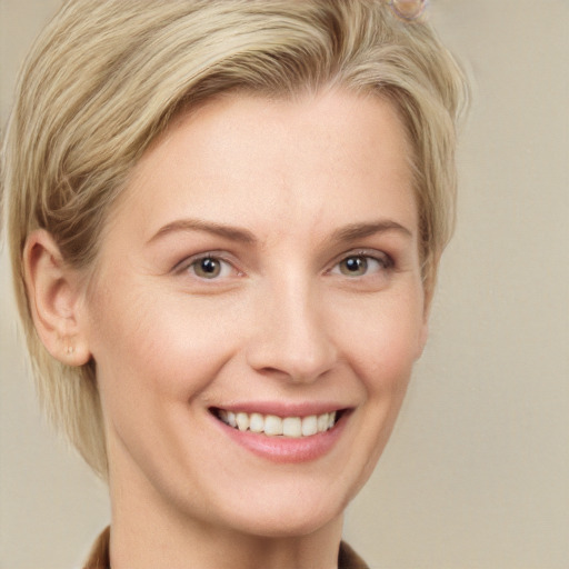 Joyful white young-adult female with short  brown hair and grey eyes