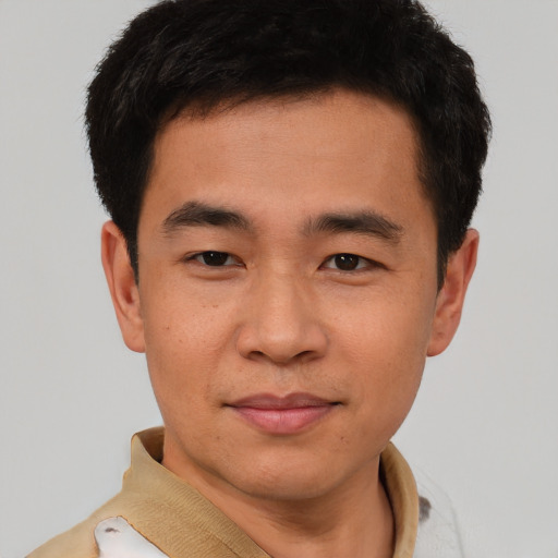 Joyful asian young-adult male with short  brown hair and brown eyes