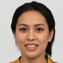 Joyful asian young-adult female with medium  brown hair and brown eyes