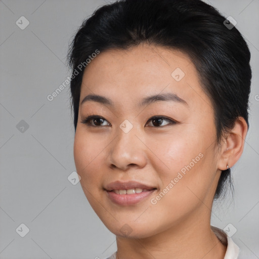 Joyful asian young-adult female with short  black hair and brown eyes