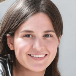 Joyful white young-adult female with long  brown hair and blue eyes