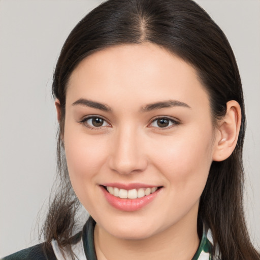 Joyful white young-adult female with long  brown hair and brown eyes