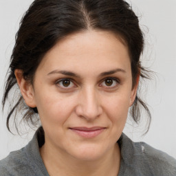 Joyful white adult female with medium  brown hair and brown eyes