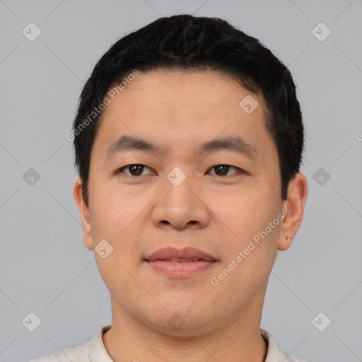 Joyful asian young-adult male with short  black hair and brown eyes