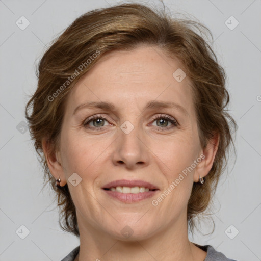 Joyful white adult female with medium  brown hair and grey eyes