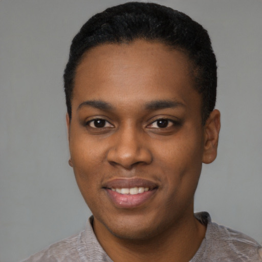 Joyful black young-adult male with short  black hair and brown eyes