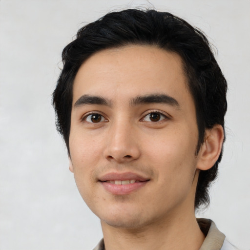 Joyful asian young-adult male with short  black hair and brown eyes