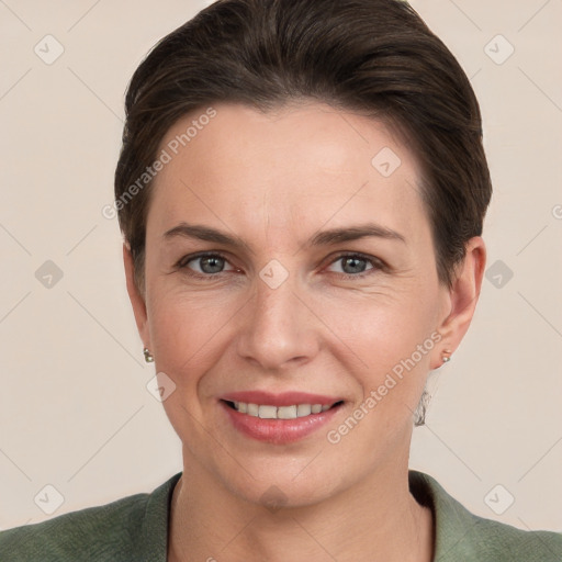 Joyful white adult female with short  brown hair and grey eyes