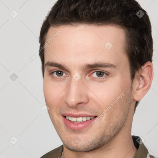 Joyful white young-adult male with short  brown hair and brown eyes