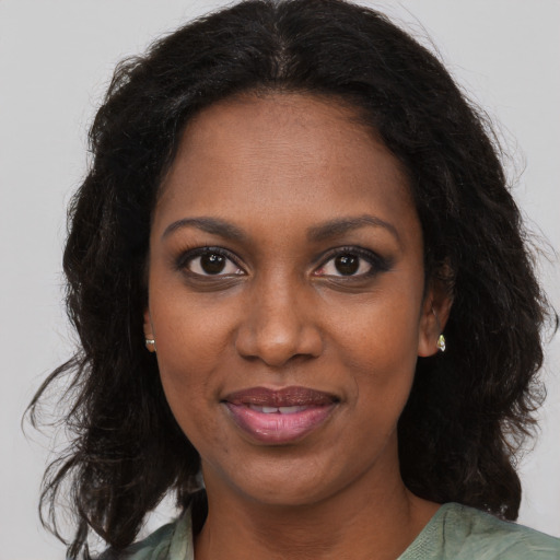 Joyful black young-adult female with medium  brown hair and brown eyes