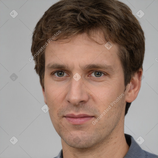 Joyful white adult male with short  brown hair and grey eyes