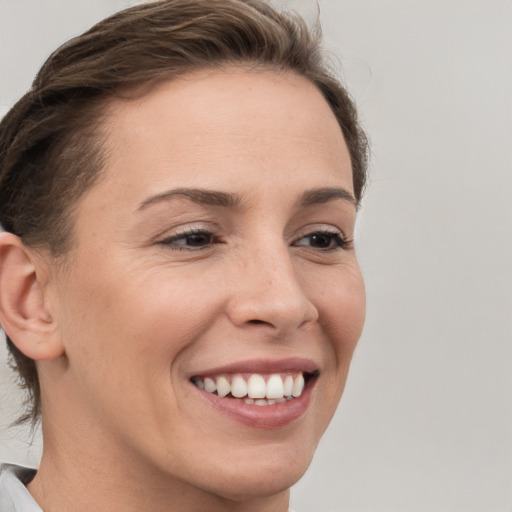 Joyful white young-adult female with short  brown hair and brown eyes