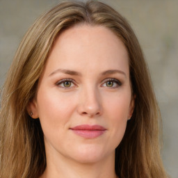 Joyful white young-adult female with long  brown hair and green eyes