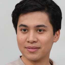 Joyful asian young-adult male with short  brown hair and brown eyes