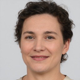 Joyful white adult female with short  brown hair and brown eyes