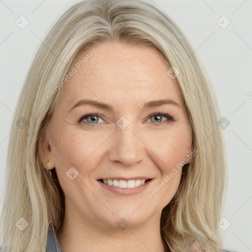 Joyful white adult female with long  brown hair and blue eyes