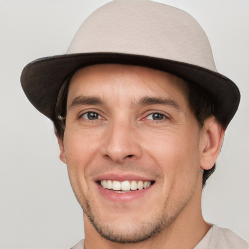 Joyful white young-adult male with short  brown hair and brown eyes