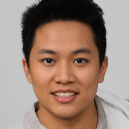 Joyful asian young-adult male with short  brown hair and brown eyes