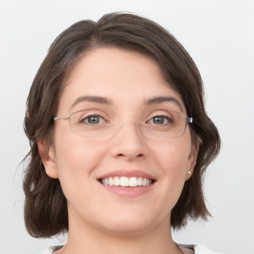 Joyful white young-adult female with medium  brown hair and green eyes