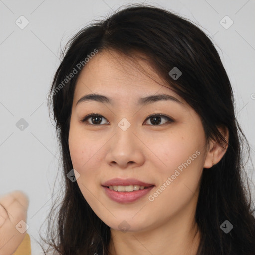 Joyful asian young-adult female with long  brown hair and brown eyes