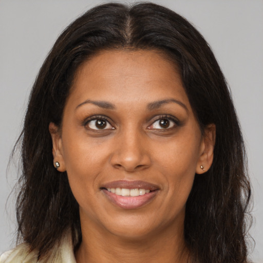 Joyful black young-adult female with medium  brown hair and brown eyes