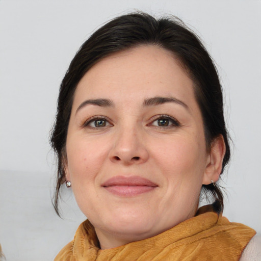 Joyful white adult female with medium  brown hair and brown eyes