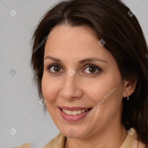 Joyful white adult female with medium  brown hair and brown eyes