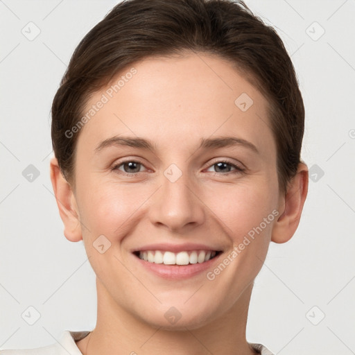 Joyful white young-adult female with short  brown hair and grey eyes