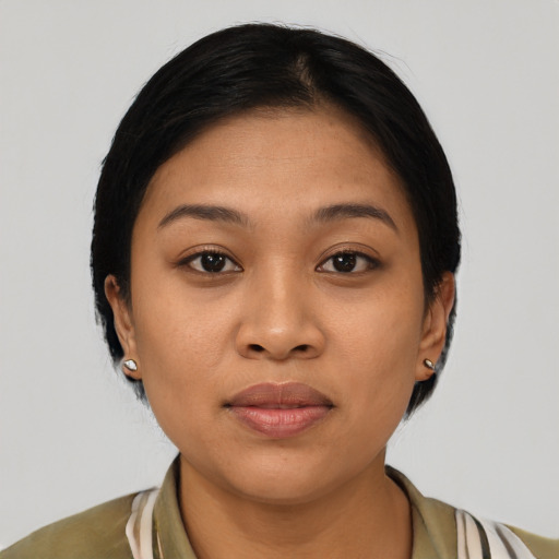 Joyful latino young-adult female with medium  brown hair and brown eyes