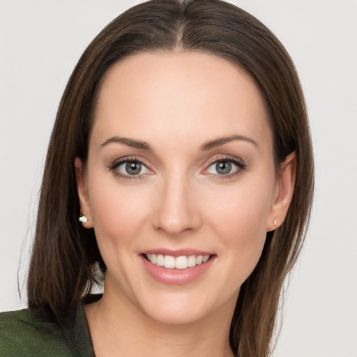 Joyful white young-adult female with long  brown hair and grey eyes