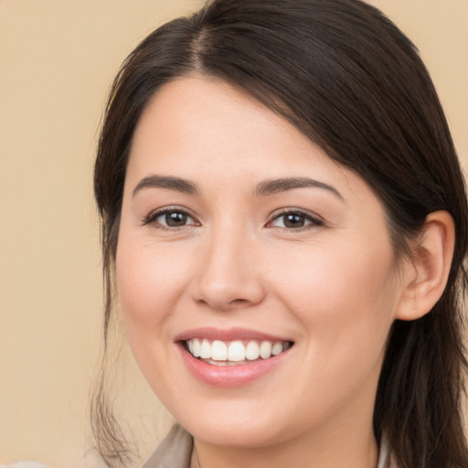 Joyful white young-adult female with medium  brown hair and brown eyes