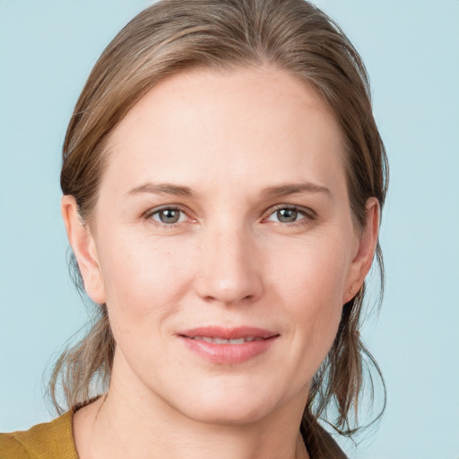 Joyful white young-adult female with medium  brown hair and blue eyes