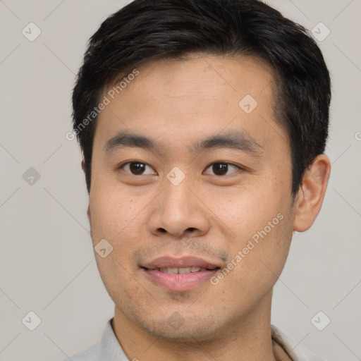 Joyful asian young-adult male with short  brown hair and brown eyes