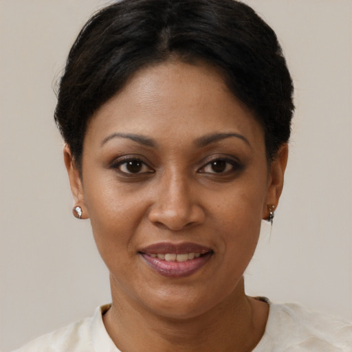 Joyful black adult female with short  brown hair and brown eyes