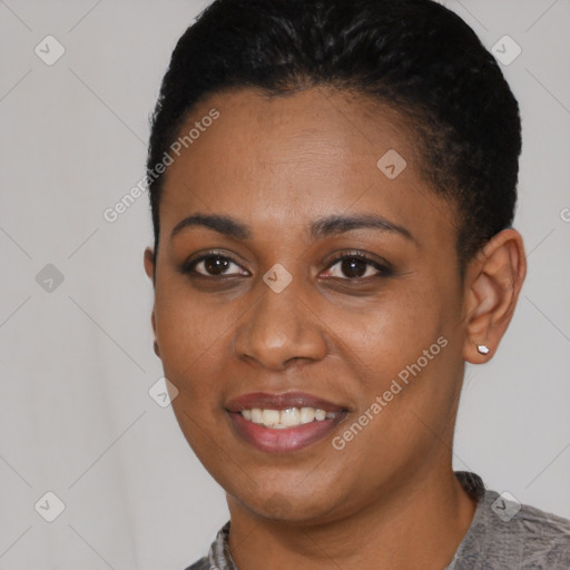 Joyful black young-adult female with short  black hair and brown eyes