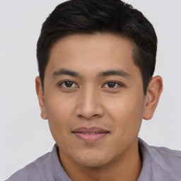 Joyful asian young-adult male with short  black hair and brown eyes